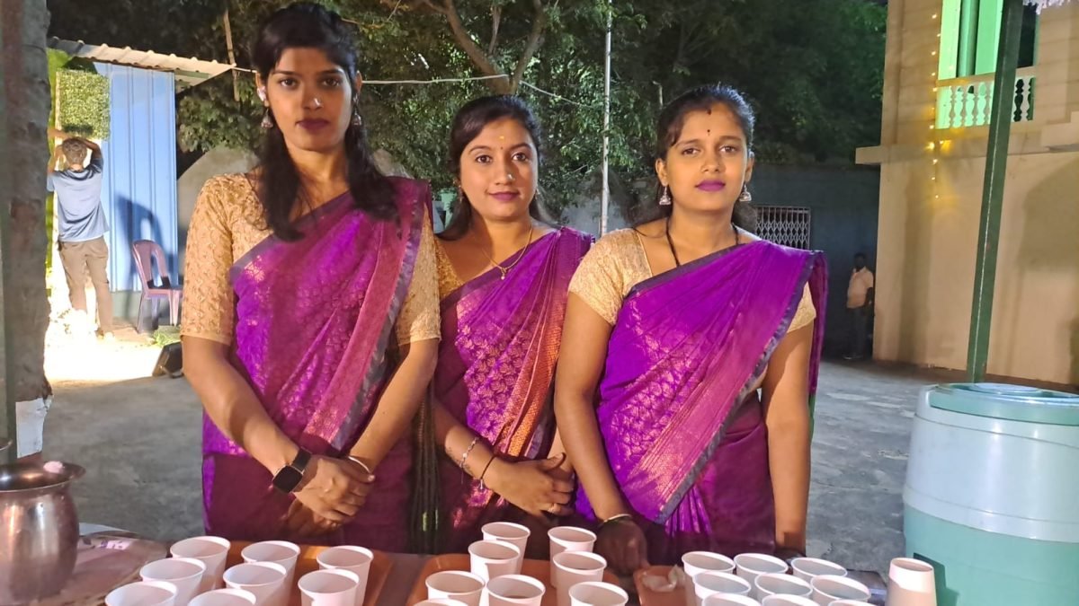 Sri Lakshmi Caterers service team in matching purple sarees at an event