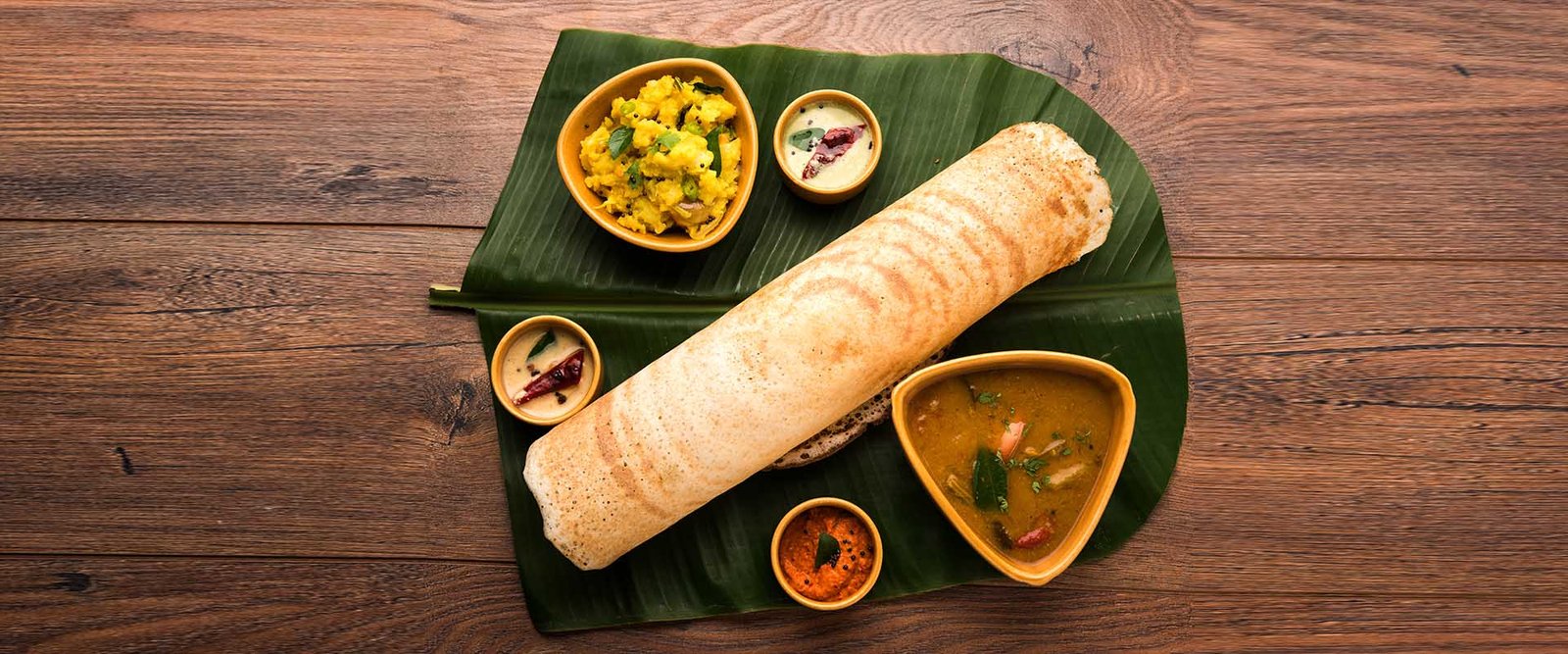 Dosa served made-to-order from a live dosa station at a reception
