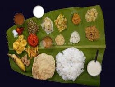 Rice varieties and curries laid out on a banana leaf for a Brahmin wedding