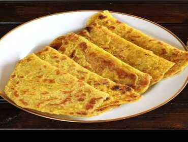 Stack of freshly made obbattu holige for Ugadi festival catering