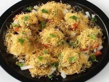 Sev puri assembled fresh at a reception chaat counter