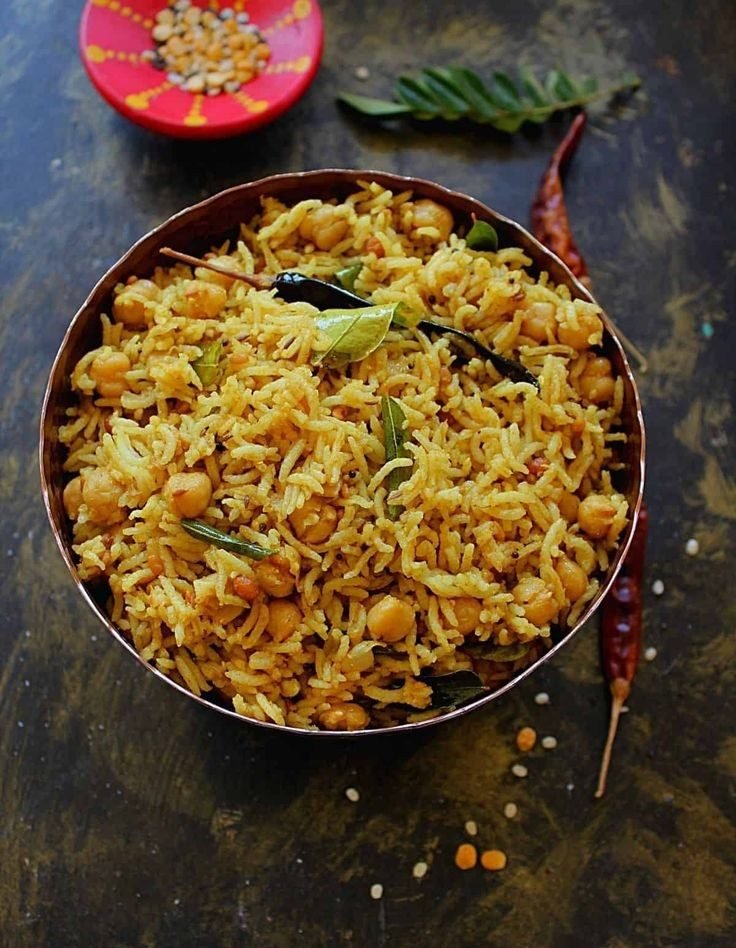 Gongura pulihora cooked in a large kadai for Andhra catering in Bangalore