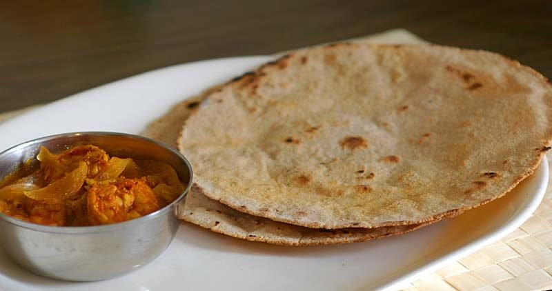Soft pulkas served alongside Andhra curries at a catered meal