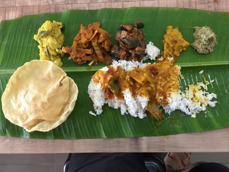 Brahmin meal with papad and accompaniments on a banana leaf