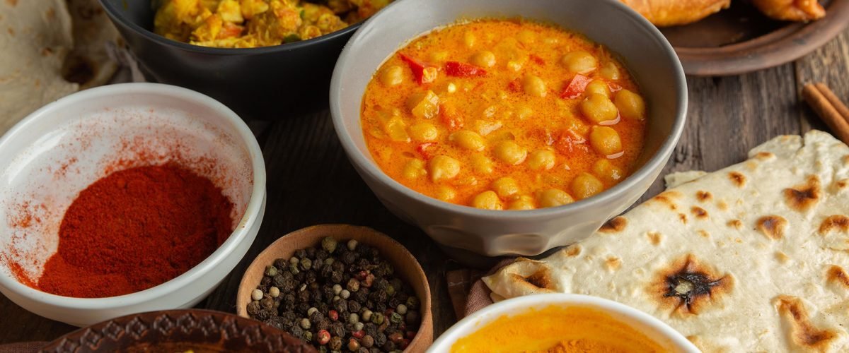 Dal makhani served with naan and whole spices at a North Indian counter