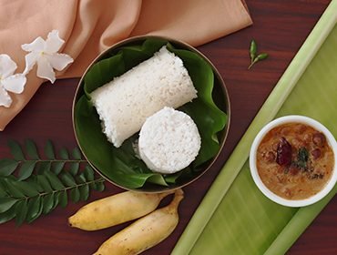 Steamed puttu served with banana, a Kerala breakfast staple