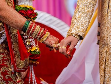 Hands performing a Tamil Brahmin wedding ritual during the ceremony