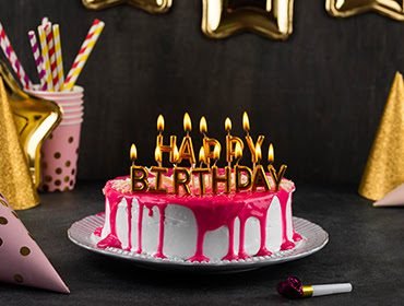 Birthday cake with lit candles at a family celebration