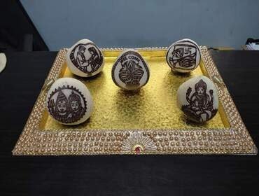Decorative kopparai presented in a seer varisai tray